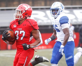 YSU's Tevin McCaster runs with the ball as Indiana State's Jamal Jones runs after him during their game at Stambaugh Stadium on Saturday. EMILY MATTHEWS | THE VINDICATOR