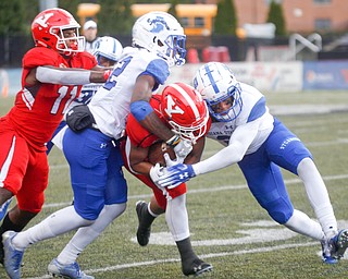 YSU's Christian Turner gets tackled by Indiana State's Dwayne Thompson II, left, and Lonnie Walker II while YSU's Jermiah Braswell, 11, attempts to block during their game at Stambaugh Stadium on Saturday. EMILY MATTHEWS | THE VINDICATOR