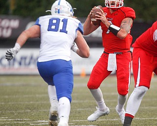 YSU's Nathan Mays prepares to throw the ball as Indiana State's Cade Peratt runs towards him during their game at Stambaugh Stadium on Saturday. EMILY MATTHEWS | THE VINDICATOR