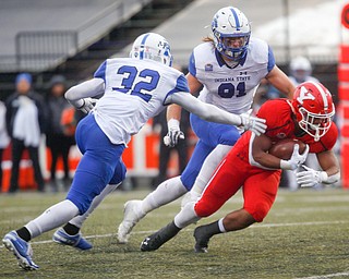 YSU's Christian Turner gets tackled by Indiana State's Tyreeon Hambright, 32, and Cade Peratt during their game at Stambaugh Stadium on Saturday. EMILY MATTHEWS | THE VINDICATOR