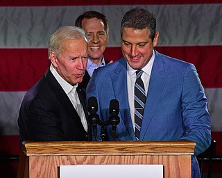 YOUNGSTOWN, OHIO - OCTOBER 29, 2018: Former Vice President of the United States Joe Biden, left, embraces United States Congressmen Tim Ryan at the podium in support of Ohio gubernatorial candidate Richard Cordray, Monday afternoon at Youngstown State University. DAVID DERMER | THE VINDICATOR