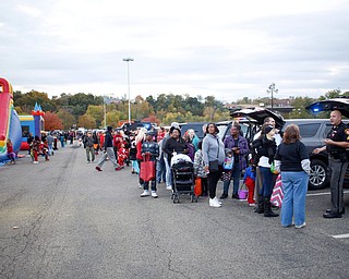 A line of people trick or treat during the Halloween event at Covelli Centre on Tuesday. EMILY MATTHEWS | THE VINDICATOR
