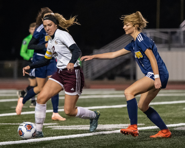 DIANNA OATRIDGE | THE VINDICATOR  South Range's Rachel Maynard (12) tries to keep the ball away from Kirtland's Tea Petric during their Division III regional semifinal in Solon on Tuesday.
