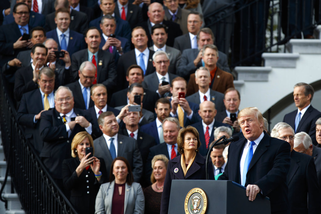 In this Dec. 20, 2017, file photo, President Donald Trump speaks during an event on the South Lawn of the White House in Washington to acknowledge the final passage of tax overhaul legislation by Congress. Perhaps nowhere is the choice facing voters more vivid than in the battle for control of the House, where Democrats are fielding more women and female minority candidates than ever while Republicans are trying to hold the majority with mostly white men. The disparity highlights a trend that has been amplified under President Donald Trump, with the two parties increasingly polarized along racial and gender lines as much as by the issues.