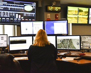 In this March 15, 2018, file photo a dispatcher works at a desk station with a variety of screens used by those who take 911 emergency calls in Roswell, Ga. The Roswell call center is one of the few in the United States that accepts text messages. Most places in the U.S. don’t have access to text-to-911 services, an increasingly crucial gap during an era of mass shootings and other catastrophes, when a phone call is not always an option.