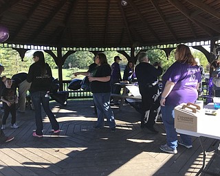 Neighbors | Jessica Harker .Family and friends gathered early Oct. 15 in a pavillion in Austintown Park blowing up balloons in preperation for the third annual Step Out Against Bullying memorial walk.