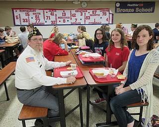 Neighbors | Jessica Harker.Navy Veteran Frank Young sits with students during their lunch break at Austintown Fitch Oct. 24.