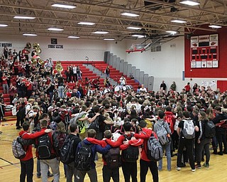 Neighbors | Abby Slanker.To close Canfield High School’s pep rally, the students gathered on the gym floor, and accompanied by the marching band, sang the school’s Alma Mater on Oct. 26.