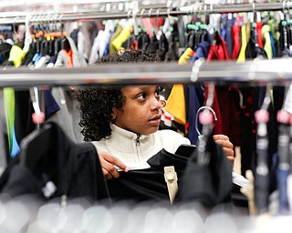 Landen Fitzgerald-Green, 8, looks at shirts in the Burlington store in Boardman during a shopping spree his family received to celebrate his recovery from Leukemia on Thursday. EMILY MATTHEWS | THE VINDICATOR