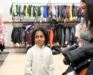 Landen Fitzgerald-Green, 8, shows him mom Lisa Fitzgerald-Green shoes he picked out in the Burlington store in Boardman during a shopping spree his family received to celebrate his recovery from Leukemia on Thursday. EMILY MATTHEWS | THE VINDICATOR