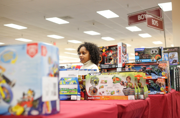 Landen Fitzgerald-Green, 8, looks at toys in the Burlington store in Boardman during a shopping spree his family received to celebrate his recovery from Leukemia on Thursday. EMILY MATTHEWS | THE VINDICATOR