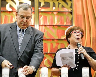 Rick and Ronna Marlin speak about and light a candle for Rose Mallinger, one of the victims of the shooting at the Tree of Life Synagogue, during an interfaith vigil for the Pittsburgh Tree of Life Synagogue victims at Temple El Emeth in Liberty on Thursday evening. EMILY MATTHEWS | THE VINDICATOR