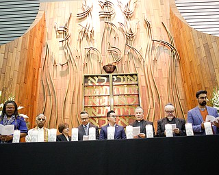 All clergy stand behind candles that represent the victims of the shooting at the Tree of Life Synagogue in Pittsburgh during the end of an interfaith vigil for the Pittsburgh Tree of Life Synagogue victims at Temple El Emeth in Liberty on Thursday evening. EMILY MATTHEWS | THE VINDICATOR