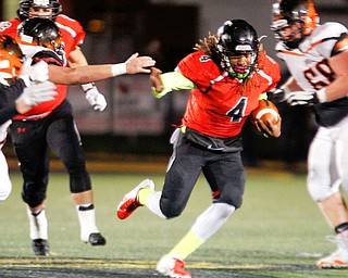Canfield's Mehlyn Clinkscale runs the ball past Marlington to eventually score a touchdown during the first half of their game at Canfield on Friday. EMILY MATTHEWS | THE VINDICATOR