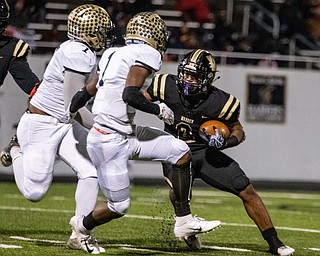DIANNA OATRIDGE | THE VINDICATOR  Warren Harding's Kayron Adams (2) looks for running room against Garfield Heights' defenders Dimarco Williams (7) and Isaiah Jackson (1) during their first round playoff game at Mollenkopf Stadium in Warren on Friday.