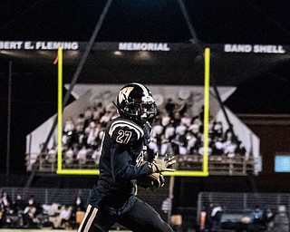 DIANNA OATRIDGE | THE VINDICATOR  Warren Harding's Elijah Smith (27) rushes with the ball on his way to the end zone in the first quarter of their first round playoff game against Garfield Heights at Mollenkopf Stadium in Warren on Friday.