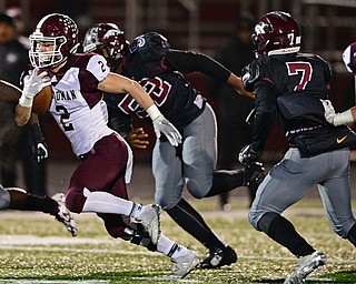 MAPLE HEIGHTS, OHIO - NOVEMBER 2, 2018: Boardman's Joe Ieraci runs away from Maple Heights' Daiquantee Glenn (52) and Antione Halloway (7) during the 1st half of their OHSAA Division II playoff game, Friday night at Maple Heights High School. DAVID DERMER | THE VINDICATOR