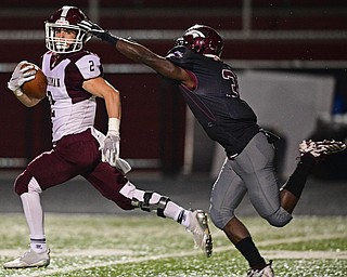 MAPLE HEIGHTS, OHIO - NOVEMBER 2, 2018: Boardman's Joe Ieraci looks back before being drug down by Maple Heights' Manny Ramsey during the 1st half of their OHSAA Division II playoff game, Friday night at Maple Heights High School. DAVID DERMER | THE VINDICATOR