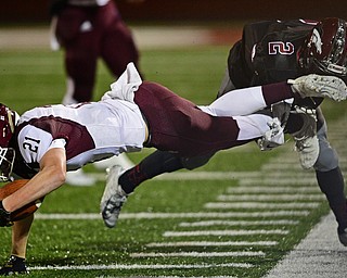 MAPLE HEIGHTS, OHIO - NOVEMBER 2, 2018: Boardman's Cam Keeps is tackled by Maple Heights' Delonte Hall during the 2nd half of their OHSAA Division II playoff game, Friday night at Maple Heights High School. DAVID DERMER | THE VINDICATOR