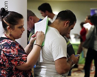 AP file photo, Jan. 30
Loredana Gonzalez of Doral, Fla., fills out a job application at a JobNewsUSA job fair in Miami Lakes, Fla. On Friday, the U.S. government issued the October jobs report, saying that employers added a strong 250,000 jobs in October and that the unemployment rate remained 3.7 percent, the lowest level in nearly 50 years.
