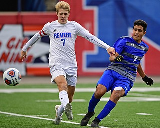 NILES, OHIO - NOVEMBER 3, 2018: Hubbard's Nader Kassem kicks the ball away from Revere's Sandor Jakab during the second half of the OHSAA Division 2 Regional Finals, Saturday afternoon at Niles High School. Hubbard's Michael VanSuch pictured. DAVID DERMER | THE VINDICATOR