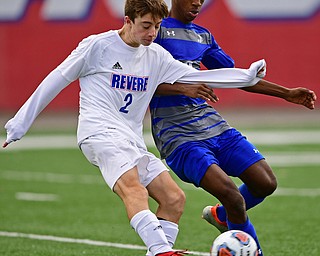 NILES, OHIO - NOVEMBER 3, 2018: Revere's Joey Klein kicks the ball away from Hubbard's Derrick Cobbin during the second half of the OHSAA Division 2 Regional Finals, Saturday afternoon at Niles High School. Hubbard's Michael VanSuch pictured. DAVID DERMER | THE VINDICATOR