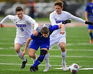 NILES, OHIO - NOVEMBER 3, 2018: Anthony Gagliardi, center, battles with Revere's Owen Alexander, left, and Trevor Rorabaugh during the second half of the OHSAA Division 2 Regional Finals, Saturday afternoon at Niles High School. Hubbard's Michael VanSuch pictured. DAVID DERMER | THE VINDICATOR