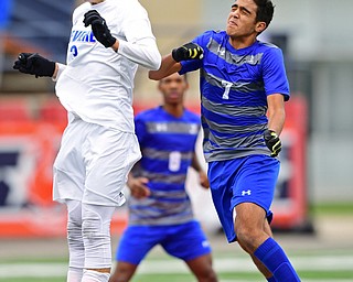 NILES, OHIO - NOVEMBER 3, 2018: Revere's Andrew Cooke heads the ball away from Hubbard's Nader Kassem during the second half of the OHSAA Division 2 Regional Finals, Saturday afternoon at Niles High School. Hubbard's Michael VanSuch pictured. DAVID DERMER | THE VINDICATOR