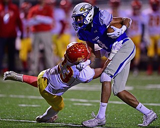 HUBBARD, OHIO - NOVEMBER 3, 2018: Hubbard's Davion Daniels is hit by Indian Creek's Trevor Fante during the first half of their OHSAA Division IV playoff game, Saturday night at the Hubbard football stadium. DAVID DERMER | THE VINDICATOR
