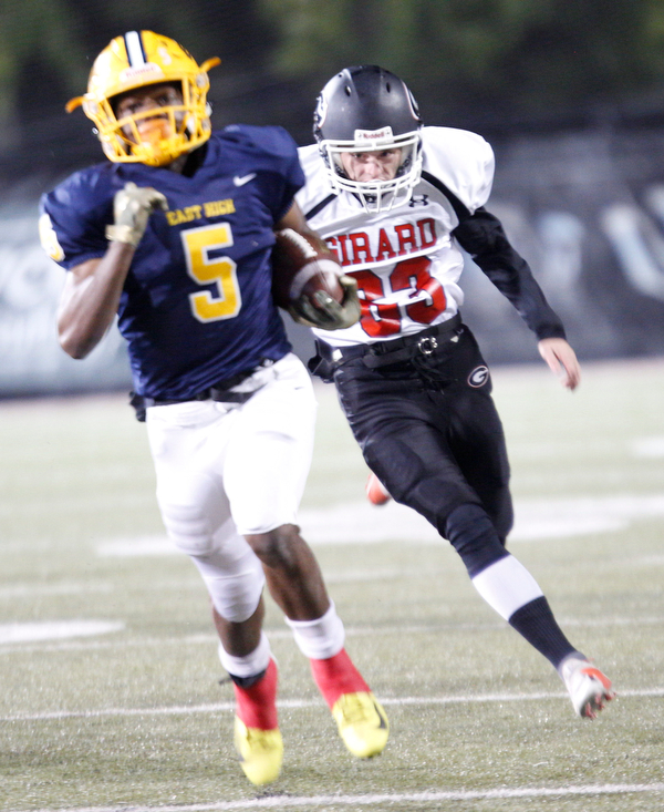 Girard's Donald Miller chases East's GeiVonni Washington down the field during the first half of their game at Stambaugh Stadium on Saturday. EMILY MATTHEWS | THE VINDICATOR