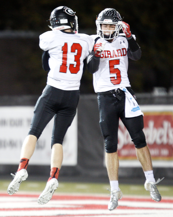 Girard's Michael Johnson, left, and Nick Malito celebrates after Malito scores a touchdown against East during the first half of their game at Stambaugh Stadium on Saturday.  EMILY MATTHEWS | THE VINDICATOR