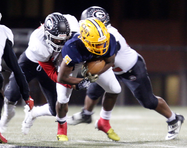 East's GeiVonni Washington gets tackled by Girard's Morgan Clardy, left, and Tyler Maddox during the first half of their game at Stambaugh Stadium on Saturday.  EMILY MATTHEWS | THE VINDICATOR