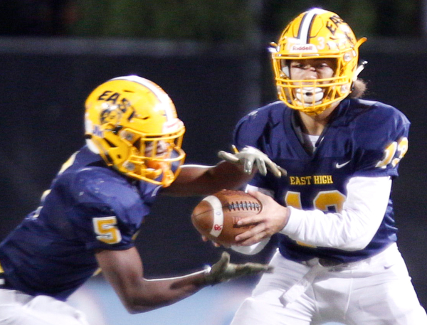 East's Delshawn Petrosky hands the ball off to GeiVonni Washington during the first half of their game against Girard at Stambaugh Stadium on Saturday.  EMILY MATTHEWS | THE VINDICATOR