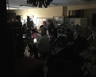 Voters cast paper ballots in New Jerusalem Church on Palmyra Road in Warren this evening. The power went out, but the Trumbull County Board of Elections send them paper ballots, allowing voting to resume. Many of the voters are using flashlights and cell phones to see their ballots.