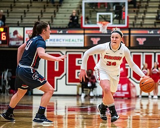 DIANNA OATRIDGE | THE VINDICATOR  Youngstown State's McKenah Peters (34) dribbles the ball upcourt against Robert Morris's Megan Callahan (13) during their game at Beeghly Center in Youngstown on Tuesday.