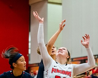 DIANNA OATRIDGE | THE VINDICATOR  Youngstown State's McKenah Peters (34) and Robert Morris's Honoka Ikematsu (20) and Julia Chadwick (24) battle for a rebound during their game at Beeghly Center in Youngstown on Tuesday.