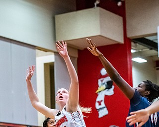 DIANNA OATRIDGE | THE VINDICATOR  Youngstown State's Sarah Cash (23) puts up a shot between Robert Morris defenders Nia Adams (20) and Irekpitan Ozzy-Momodu (14) during their game at Beeghly Center in Youngstown on Tuesday.