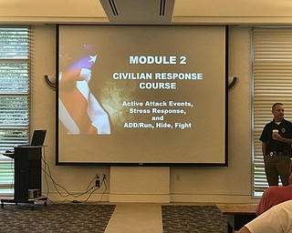 Neighbors | Jessica Harker.Officer Keith Smith was one of two Austintown police officers who gave a free civilian responce course at the library Oct. 9.