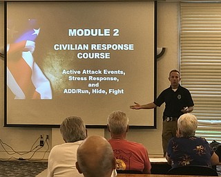 Neighbors | Jessica Harker.Officer Keith Smith gave a presentation at the Austintown library Oct. 9 about civilian responce to active shooter situations.