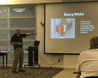 Neighbors | Jessica Harker.Officer Allen Phillips gave a presentation at the Austintown library about how community members can be prepared for active shooter situations, including cheap and effective locking mechanisms that can prevent entry.