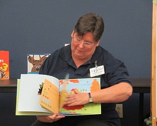 Neighbors | Jessica Harker.Librarian Karen Saunders read three books to children gathered at the Boardman library Oct. 11 for the Halloween themed story time.