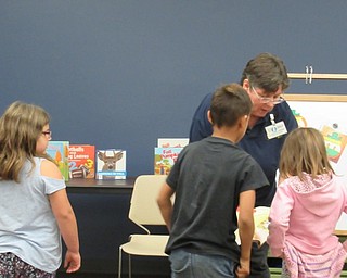 Neighbors | Jessica Harker.Children participated in the interactive story time on Oct. 11 with librarian Karen Saunders.