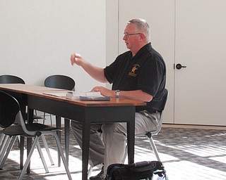 Neighbors | Jessica Harker .Robert Schaeffer, the coordinator of senior services through the Mahoning County Sheriff's office, spoke with seniors at the Austintown library about how to protect themselves from fraud and other scams Oct. 17.