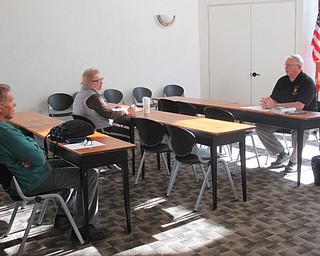 Neighbors | Jessica Harker .Community members gathered at the Austintown library Oct. 17 to meet with a representative from the Mahoning County Sheriff's office about fraud and security for seniors.