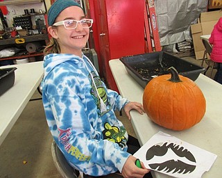 Neighbors | Jessica Harker .Christina Montgomery chose an outline to use to carve her pumpkin for the Mill Creek Parks annual pumpkin carving event where community members design pumkins to go on display Oct. 14 for the Pumpkin Walk event.