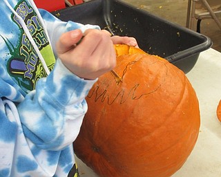 Neighbors | Jessica Harker .Christina Montgomery carved a pumpkin at the service building at Fellows Riverside Garden Oct. 12 to go on display for the annual Pumpkin Walk event.