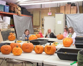 Neighbors | Jessica Harker .Groups of community members cycled through the service building at Mill Creek Park for three days carving pumpkins in preperation for the annual Pumpkin Walk event.