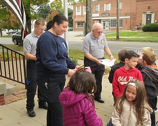 Neighbors | Jessica Harker.Students from Poland Union Elementary School handed fire fighters Abbie Buday, Chris Kothemer and Bill Ohara handmade thank-you cards on Oct. 26.