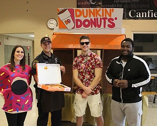 Neighbors | Abby Slanker.Canfield Local Schools Resource Officer Steve Garstka got in on the fun at Canfield High School’s annual Halloween Dress Up Day on Oct. 31. Garstka (second from left) dressed as a Dunkin’ Donuts employee and passed out 200 munchkins and coffee to students as they entered the school. Garstka was joined by CHS teacher Angela Alexandrides (left) and CHS students Ian Kristan and Shawn Rollins.