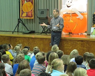 Neighbors | Jessica Harker.Poland Union Principal Mike Masucci addressed students gathered in the school's gymnasium for the Spooky Monster Magic Show.